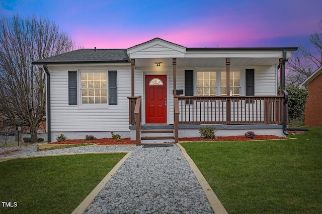 view of front of property with a porch and a lawn