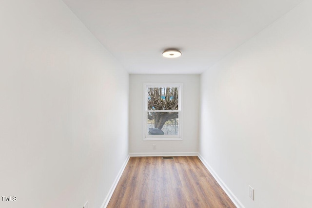 unfurnished room with hardwood / wood-style flooring