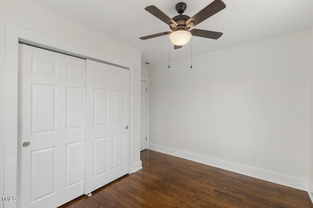 unfurnished bedroom featuring dark hardwood / wood-style flooring, a closet, and ceiling fan