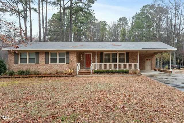 ranch-style home with a porch and a carport