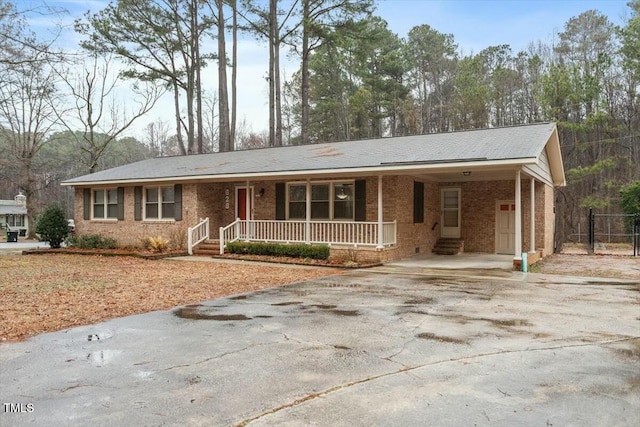 ranch-style house with a porch and a carport