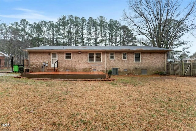 rear view of house featuring central AC, a yard, and a deck