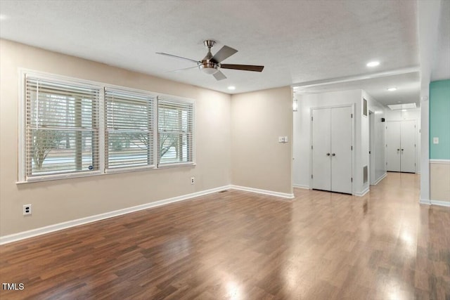 empty room with hardwood / wood-style floors, a textured ceiling, and ceiling fan