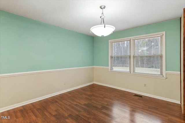 empty room with dark wood-type flooring