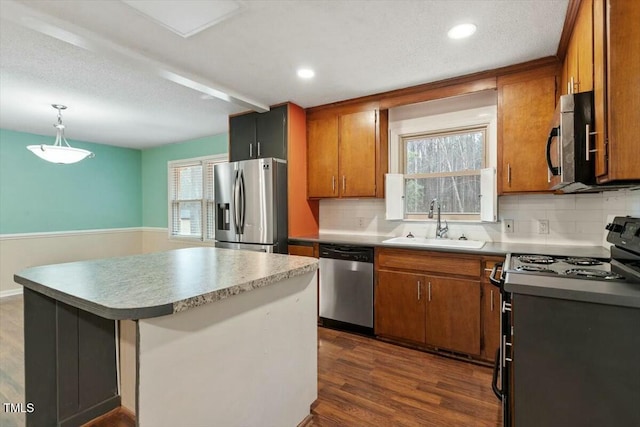 kitchen featuring sink, appliances with stainless steel finishes, dark hardwood / wood-style flooring, pendant lighting, and backsplash