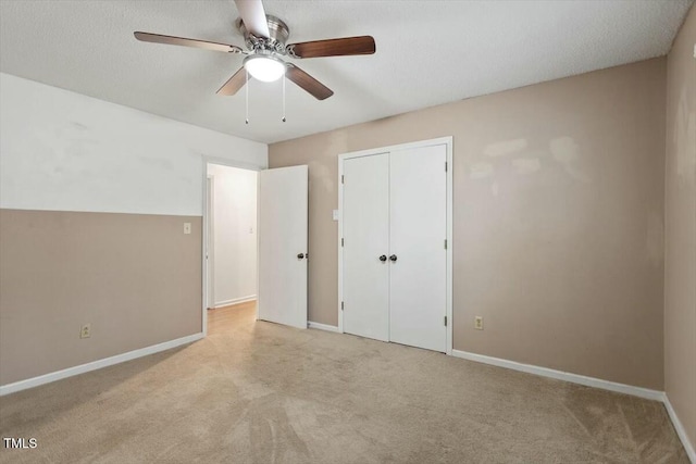 unfurnished bedroom featuring light colored carpet, ceiling fan, and a closet