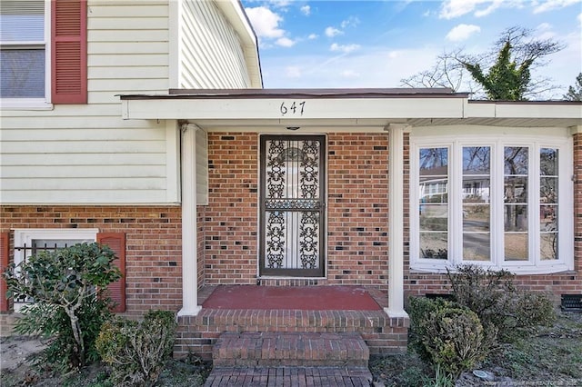 property entrance with brick siding