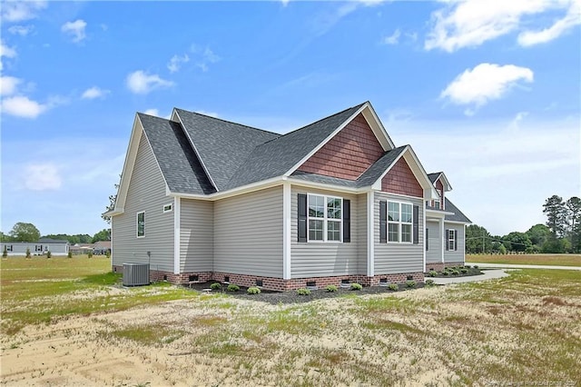 view of home's exterior with central air condition unit, a shingled roof, a lawn, and crawl space