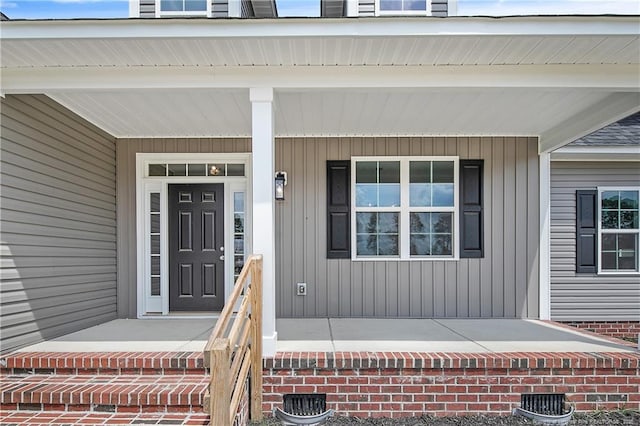 view of exterior entry with covered porch