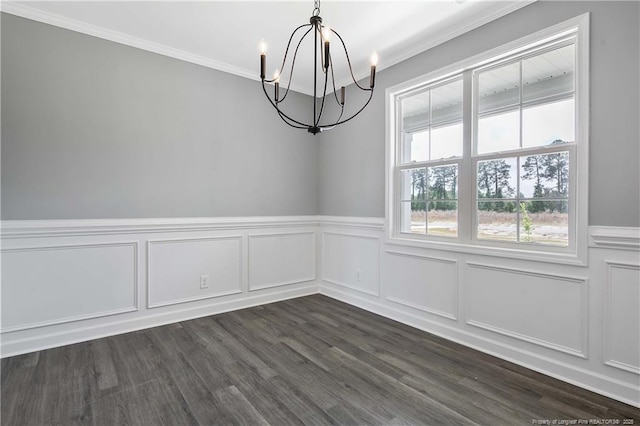 unfurnished dining area featuring an inviting chandelier, ornamental molding, wainscoting, and dark wood-style flooring
