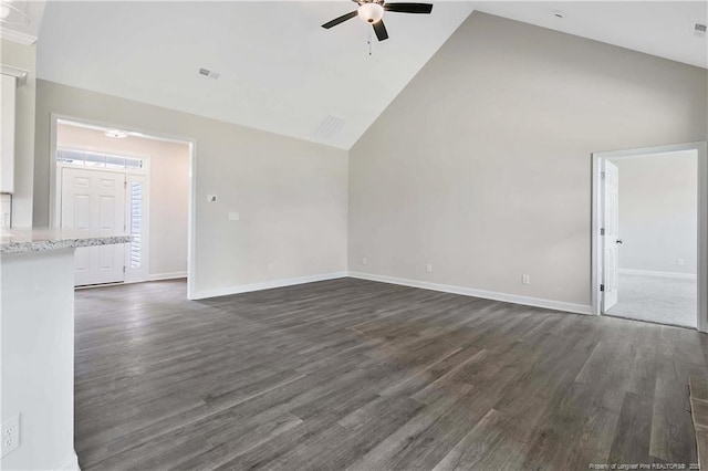 unfurnished living room with baseboards, ceiling fan, dark wood-style floors, and lofted ceiling
