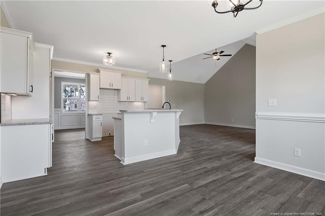 kitchen featuring dark wood-style flooring, white cabinetry, open floor plan, and ceiling fan with notable chandelier