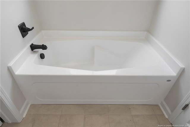 full bathroom featuring a washtub and tile patterned flooring