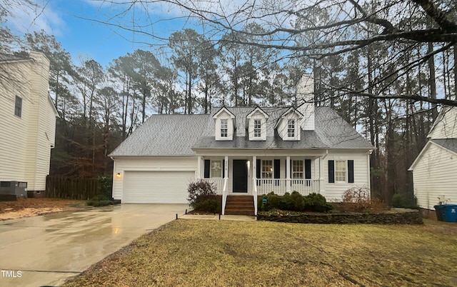 cape cod house featuring a garage, a front yard, central AC unit, and a porch