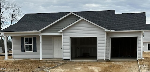 view of front of house featuring a porch and a garage