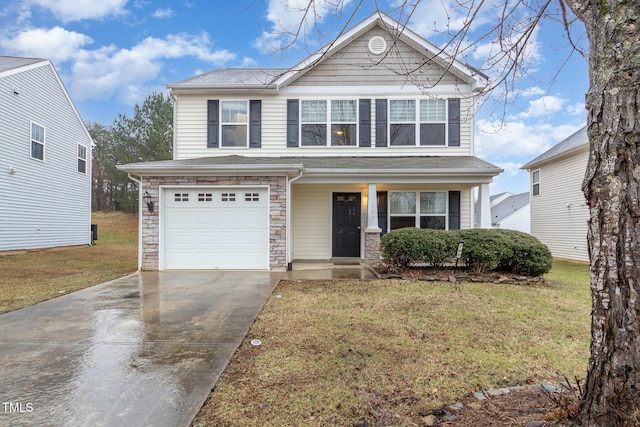 view of property with a garage and a front yard