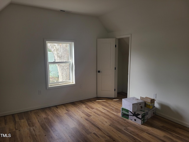 bonus room featuring wood-type flooring and vaulted ceiling