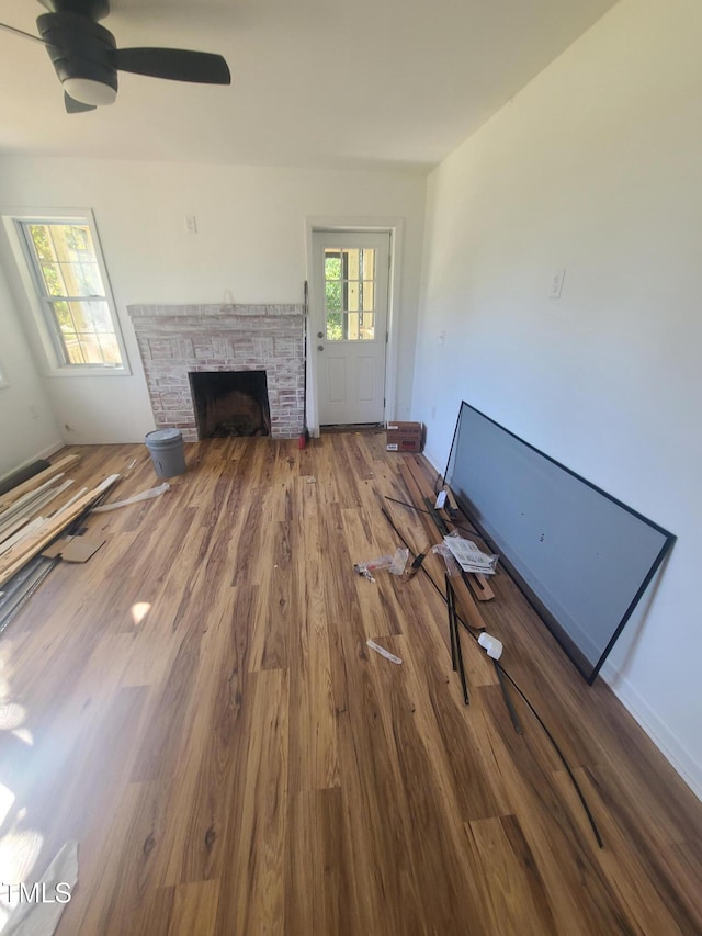 unfurnished living room featuring hardwood / wood-style floors and ceiling fan