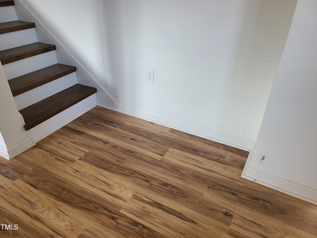 stairway featuring hardwood / wood-style flooring