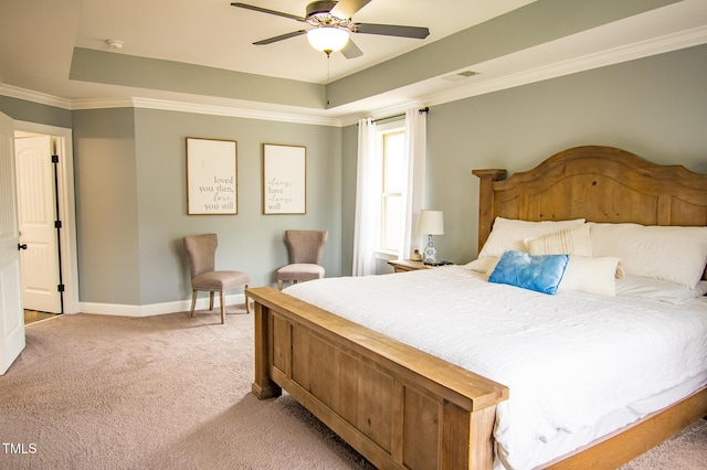 bedroom featuring light colored carpet, visible vents, baseboards, ornamental molding, and a tray ceiling