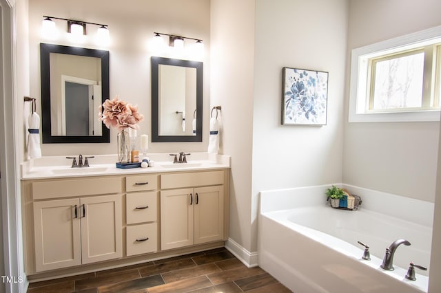 bathroom featuring a bath, double vanity, a sink, and wood finish floors