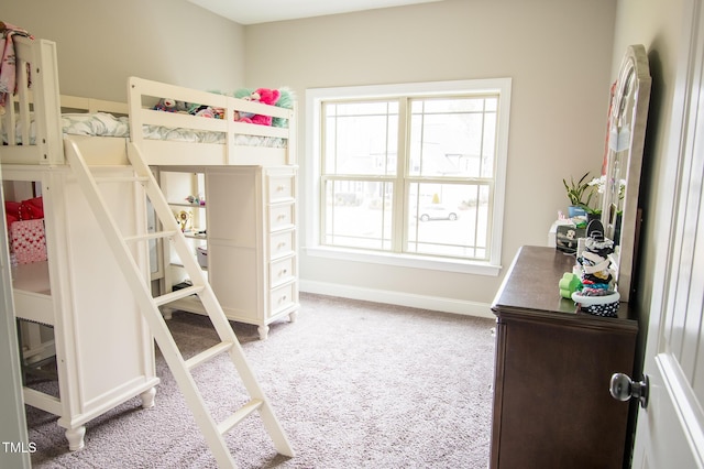 bedroom featuring baseboards and light colored carpet