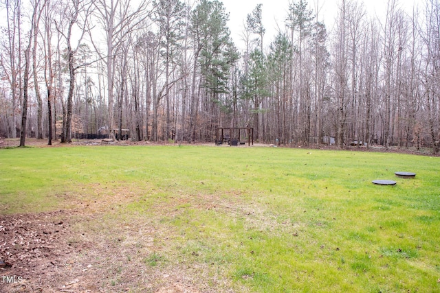 view of yard featuring a wooded view