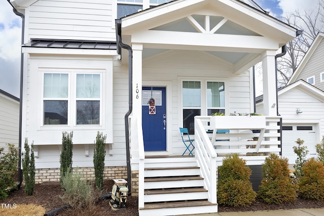 exterior space with a porch and a garage