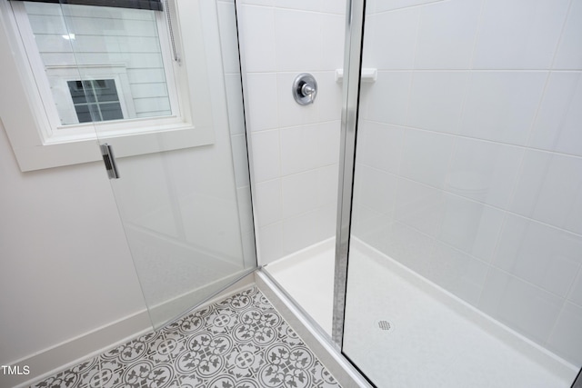 bathroom with tile patterned flooring and an enclosed shower