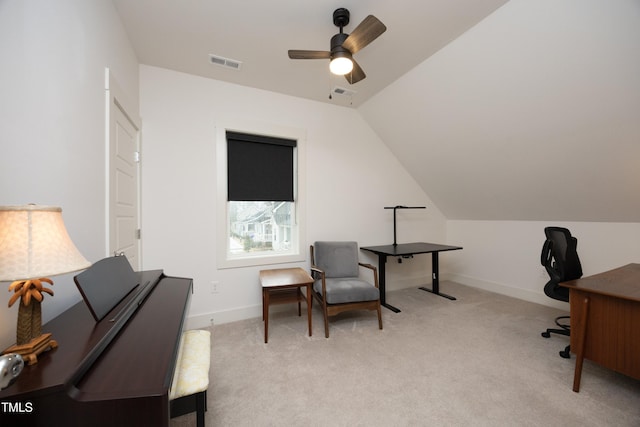 carpeted home office with ceiling fan and vaulted ceiling