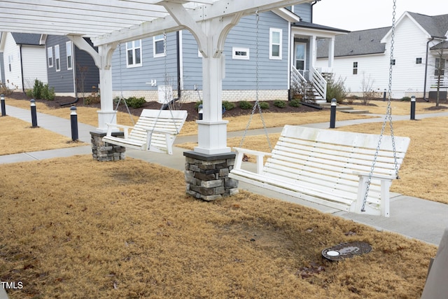 view of community with a yard and a pergola