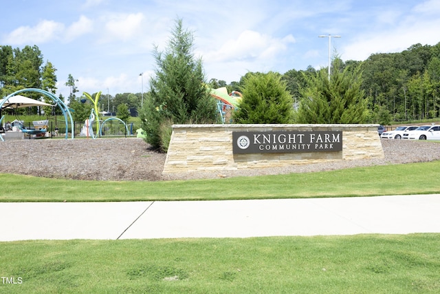 community / neighborhood sign with a lawn