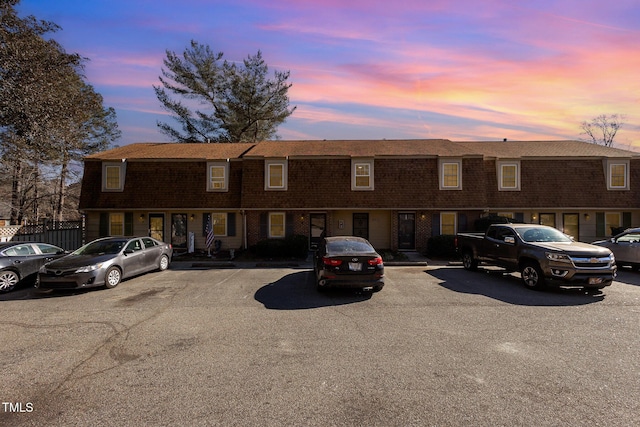 property at dusk with uncovered parking