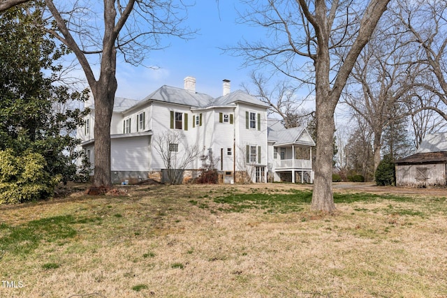 rear view of property with a yard