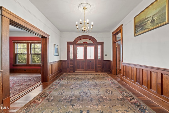 entryway featuring an inviting chandelier and hardwood / wood-style floors