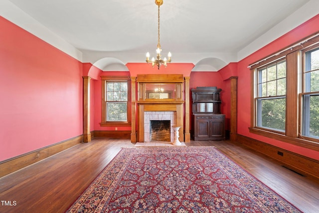 unfurnished living room with a fireplace, a healthy amount of sunlight, and light wood-type flooring