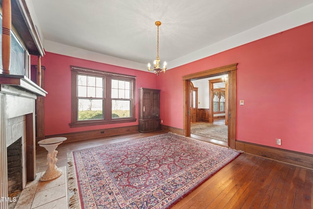 unfurnished dining area with wood-type flooring and a chandelier