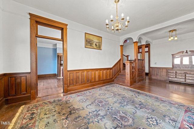 unfurnished room with dark hardwood / wood-style flooring and a chandelier