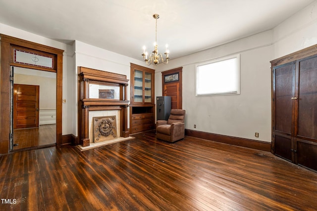 unfurnished room with dark hardwood / wood-style flooring and a chandelier