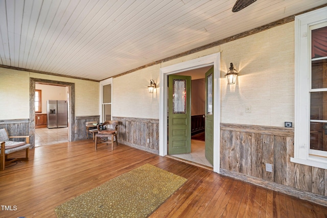 unfurnished room with wood-type flooring and wooden ceiling