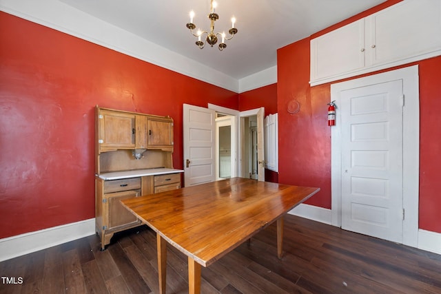 dining room featuring a notable chandelier and dark hardwood / wood-style flooring