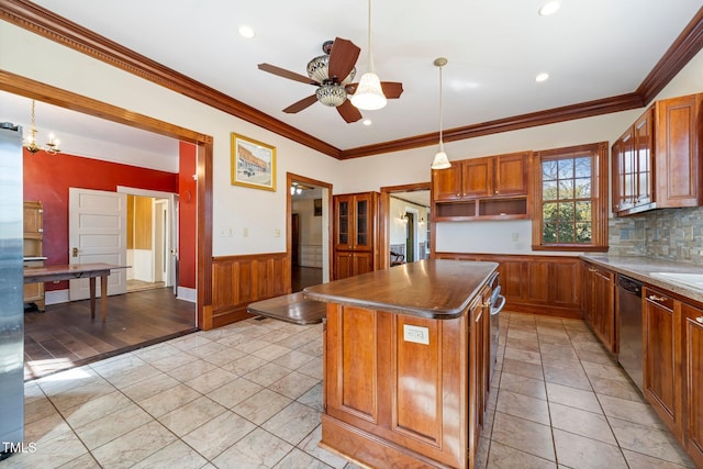 kitchen with dishwasher, crown molding, a center island, and pendant lighting