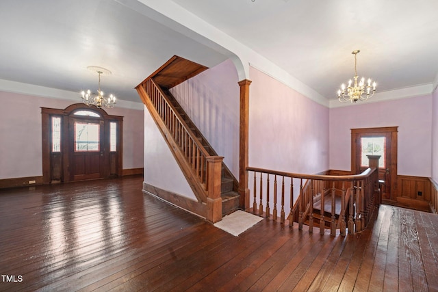 foyer entrance featuring dark hardwood / wood-style floors and a chandelier