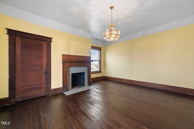 unfurnished living room featuring dark hardwood / wood-style floors and a notable chandelier