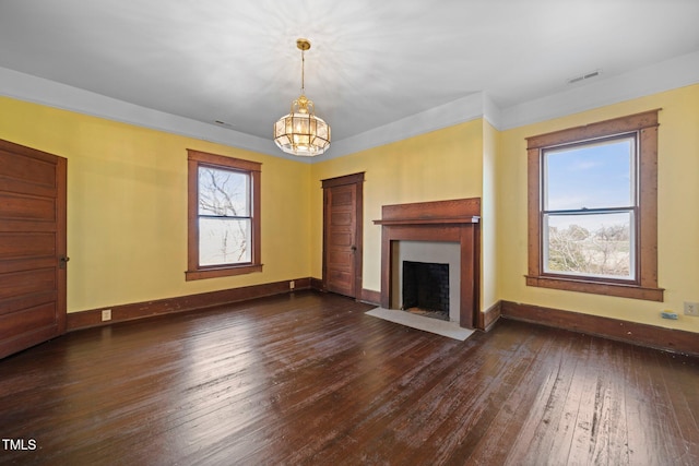 unfurnished living room featuring dark wood-type flooring and a chandelier