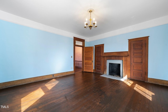 unfurnished living room featuring dark hardwood / wood-style flooring and a chandelier