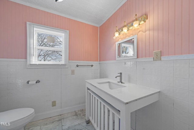 bathroom with vanity, ornamental molding, and toilet