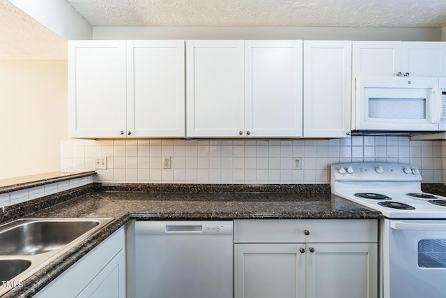 kitchen with white cabinetry, white appliances, backsplash, and a sink