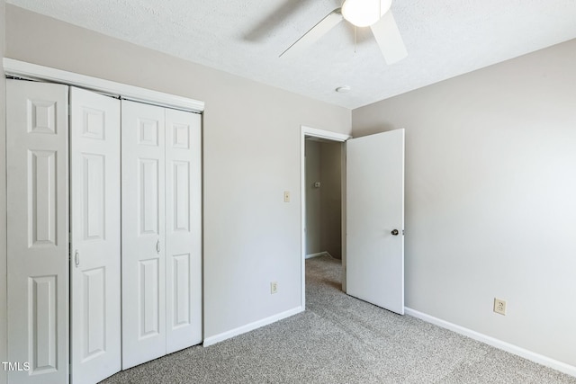 unfurnished bedroom with ceiling fan, baseboards, carpet, a closet, and a textured ceiling