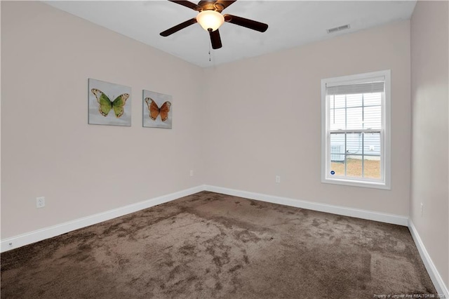 carpeted spare room with ceiling fan